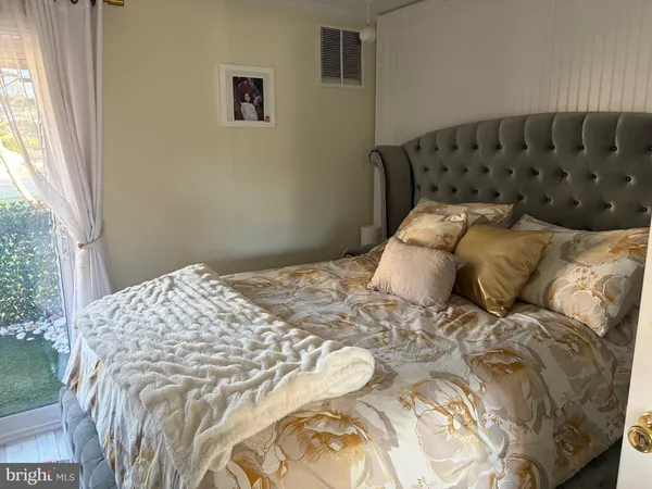 a bed sitting in a bedroom next to a window