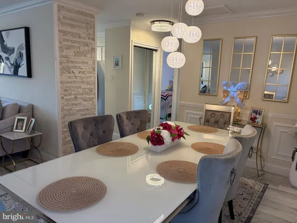 a living room with dining table and chairs