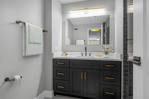 a bathroom with a sink vanity and mirror