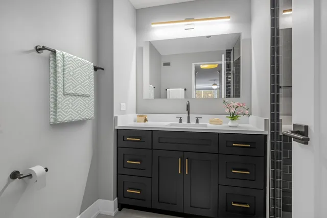 a bathroom with a sink vanity and mirror