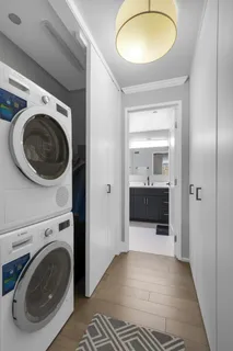 a view of a bathroom with washing machine and closet