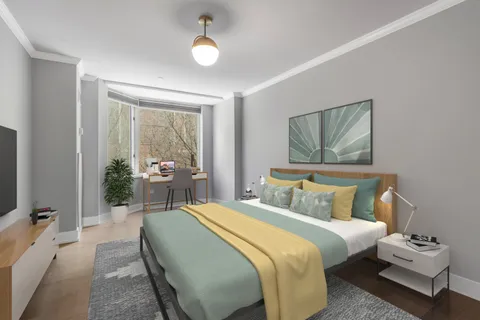 a bedroom with a bed a couch and potted plant