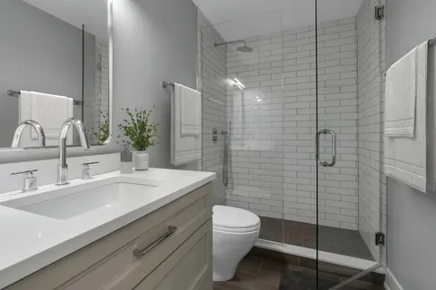 a bathroom with a sink toilet and shower