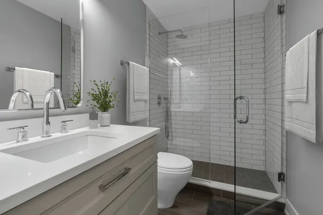 a bathroom with a sink toilet and shower