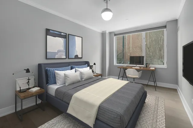 a bedroom with a bed and a large window