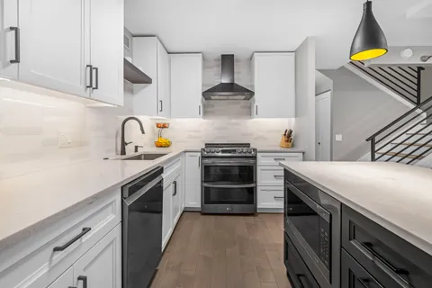 a kitchen with a stove a sink and a refrigerator