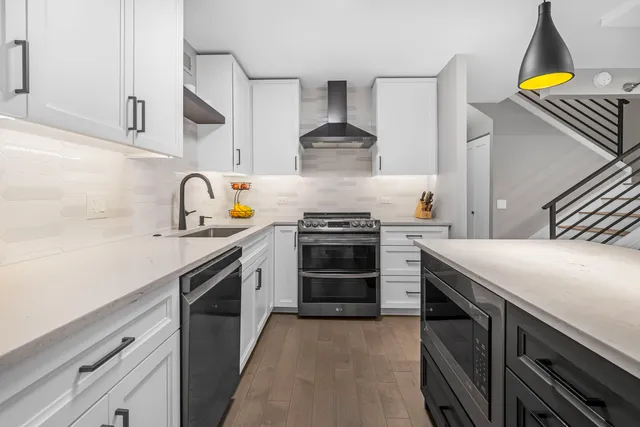 a kitchen with a stove a sink and a refrigerator