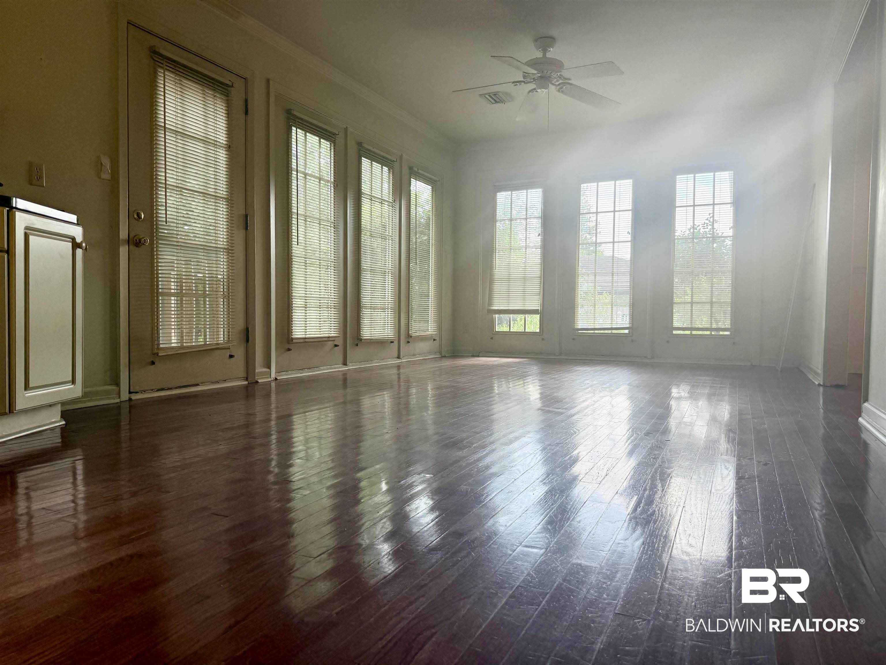 1412 Poplar Avenue Brewton, AL 36426 - Photo 12 of 32 Spare room with ceiling fan, hardwood / wood-style floors, baseboards, and crown molding