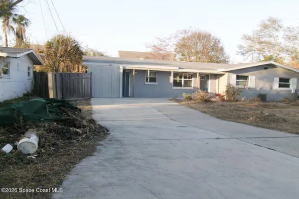 a front view of house with yard outdoor seating and barbeque oven