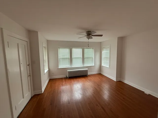 a view of wooden floor and windows in a room