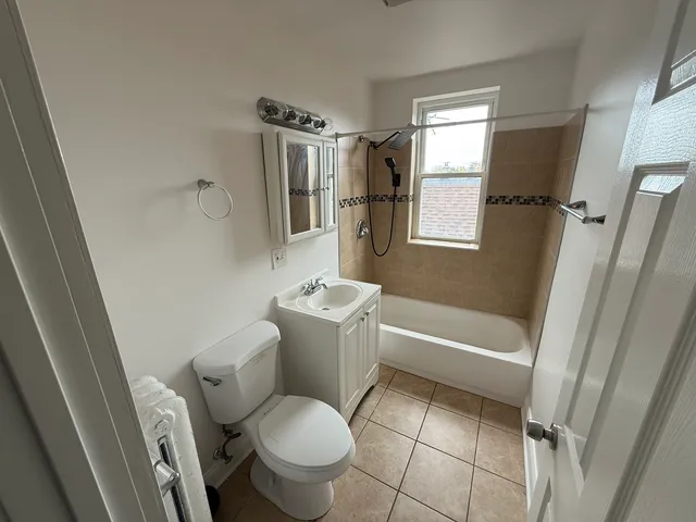 a white toilet sitting next to a bath tub