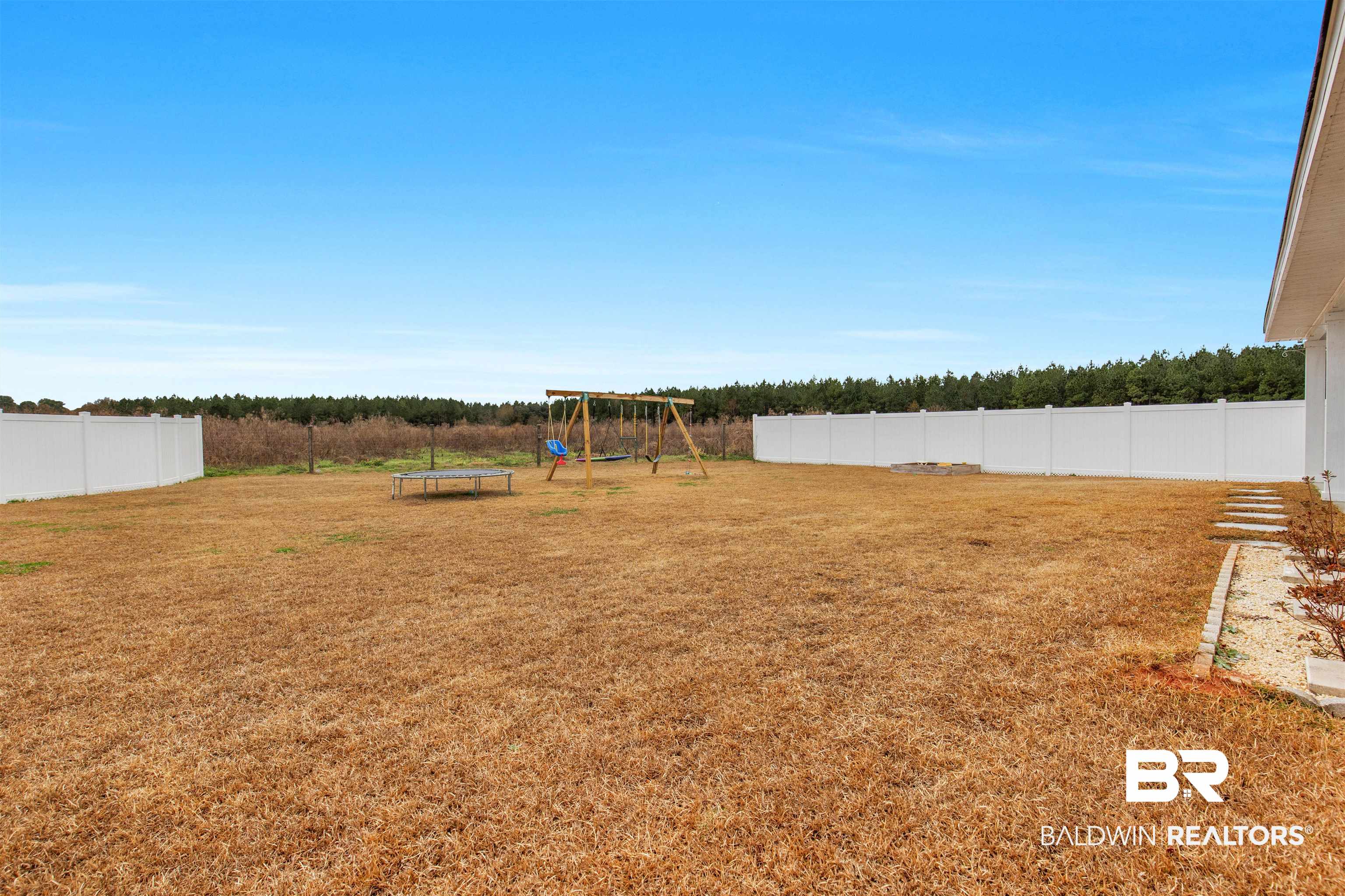10313 Ruffian Route Daphne, AL 36526 - Photo 28 of 46 View of yard featuring a playground and a trampoline