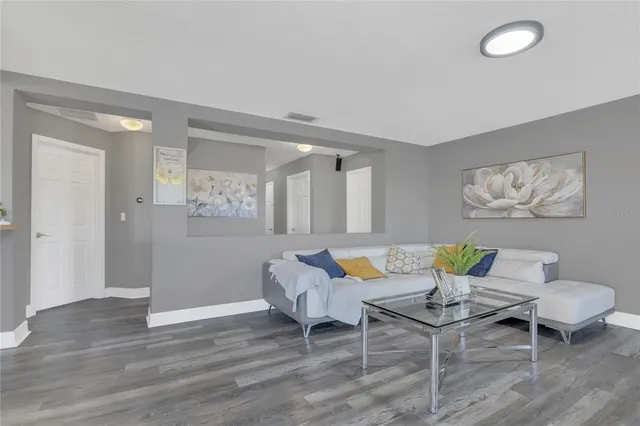 a living room with furniture and windows