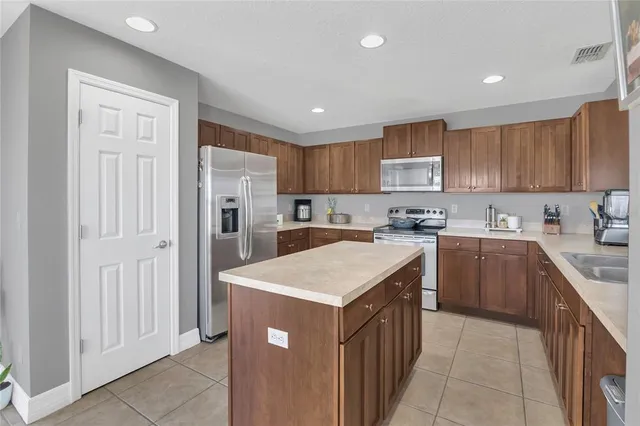 a spacious bedroom with a bed and a chandelier