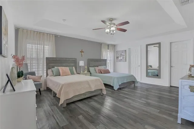 a bedroom with two beds and a chair