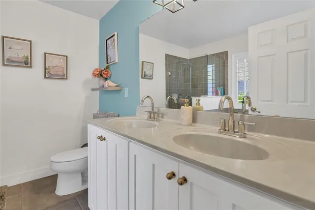 a bedroom with two beds and a chandelier