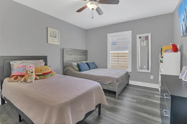 a bedroom with two beds and painting on the wall