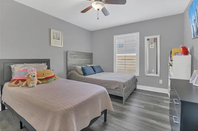 a bedroom with two beds and painting on the wall