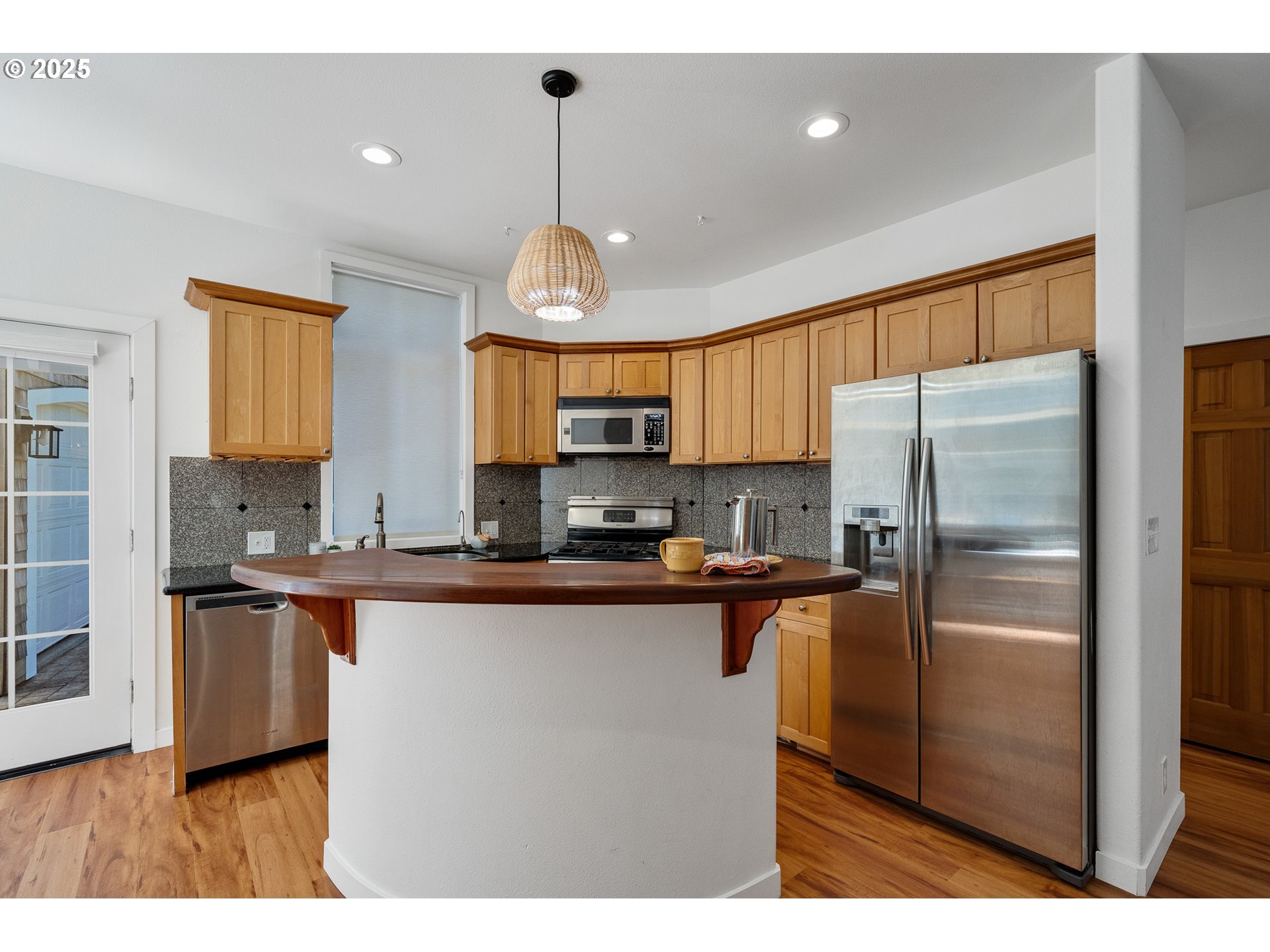 3308 Bayview Terrace Seaside, OR 97138 - Photo 12 of 48 a kitchen with stainless steel appliances granite countertop a refrigerator a sink dishwasher a stove and a cabinets