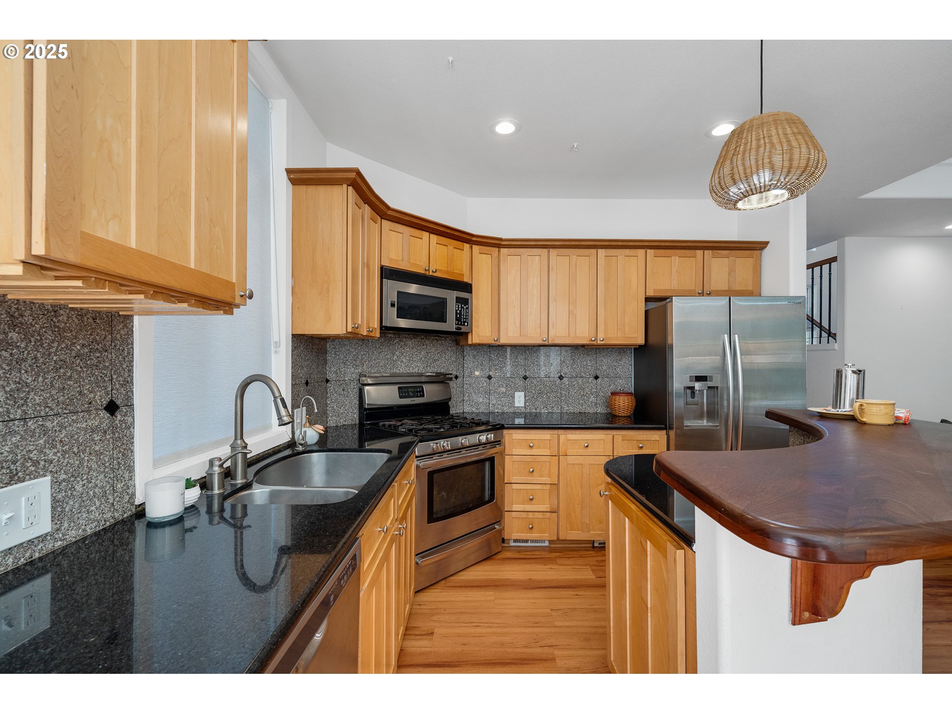 3308 Bayview Terrace Seaside, OR 97138 - Photo 13 of 48 a kitchen with stainless steel appliances granite countertop a sink refrigerator and microwave