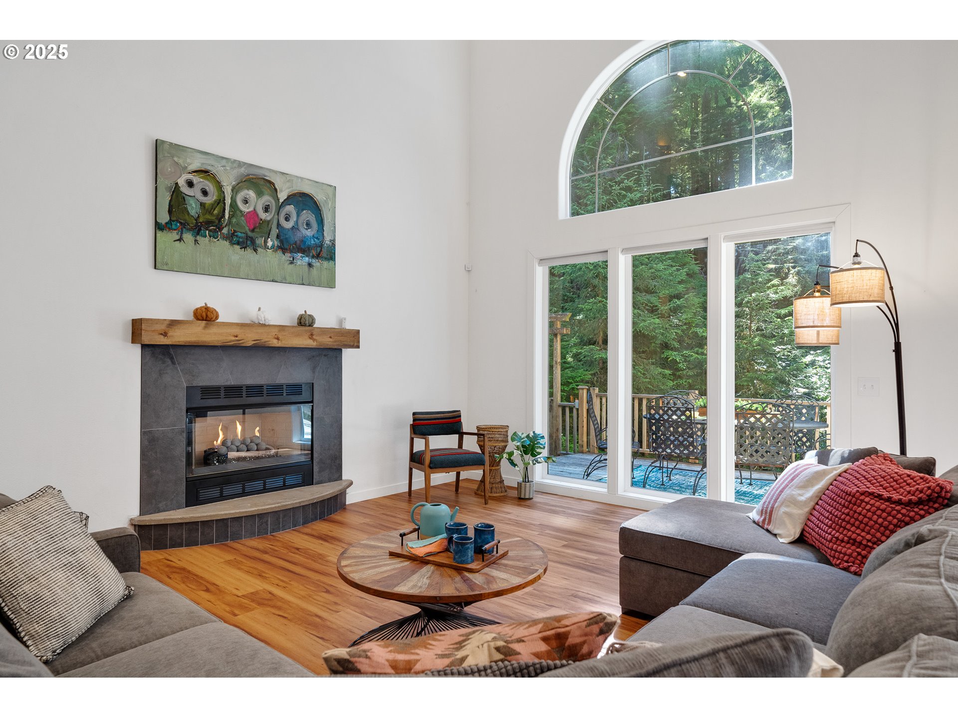 3308 Bayview Terrace Seaside, OR 97138 - Photo 5 of 48 a living room with furniture a fireplace and a large window