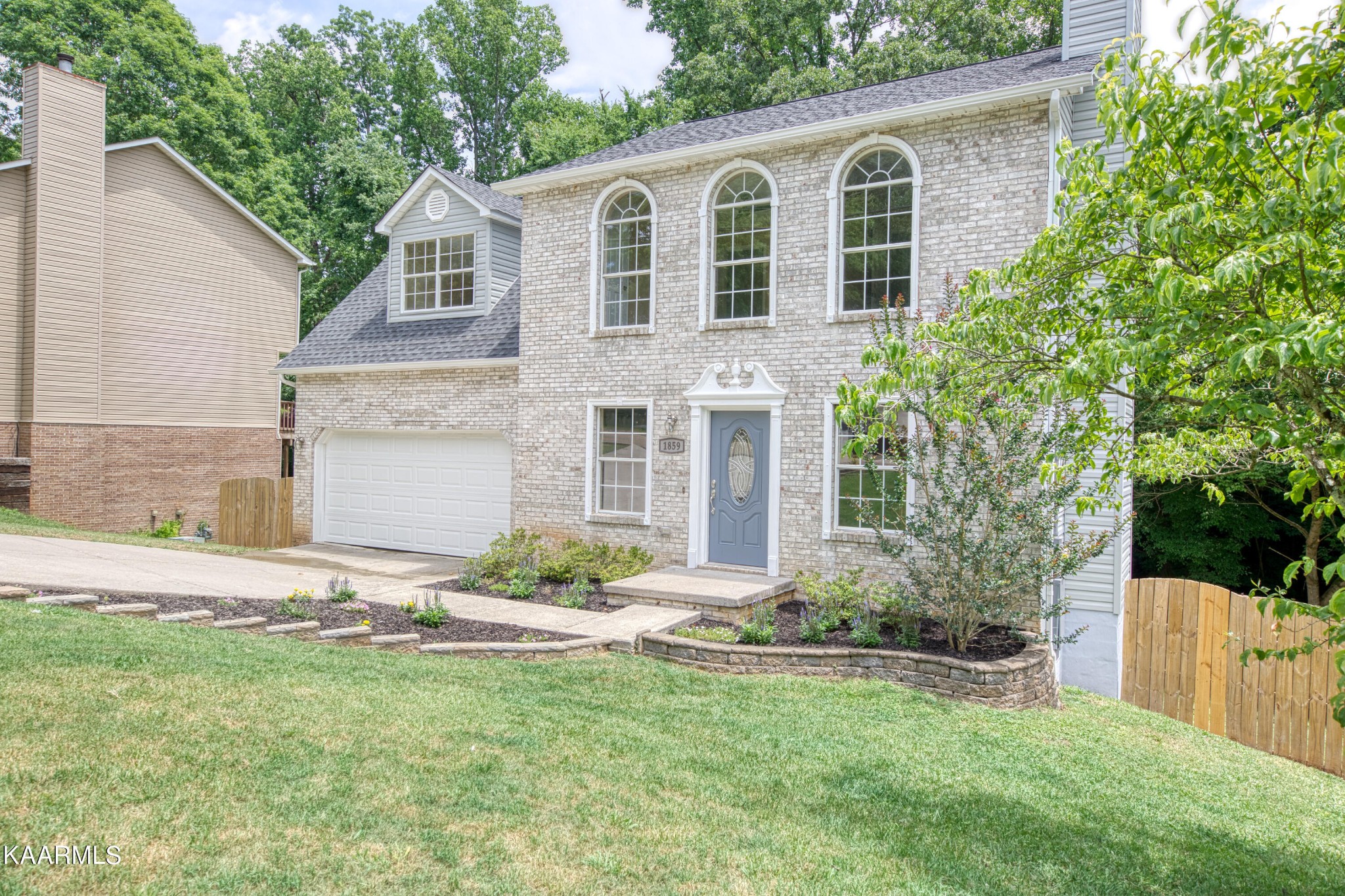 a front view of a house with a yard and garage