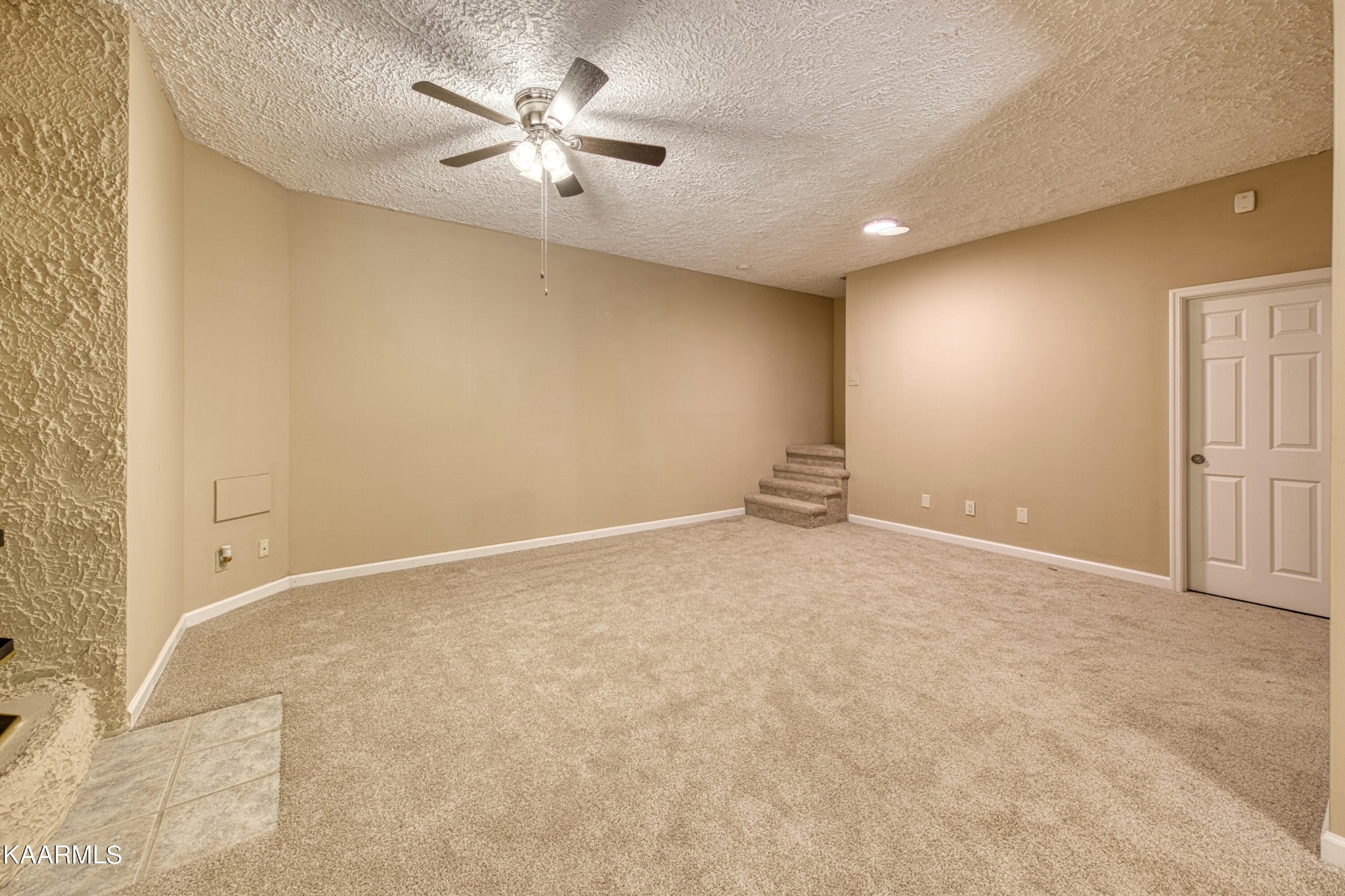 1859 Poplar Hill Road Knoxville, TN 37922 - Photo 16 of 39 an empty room with a chandelier fan and windows