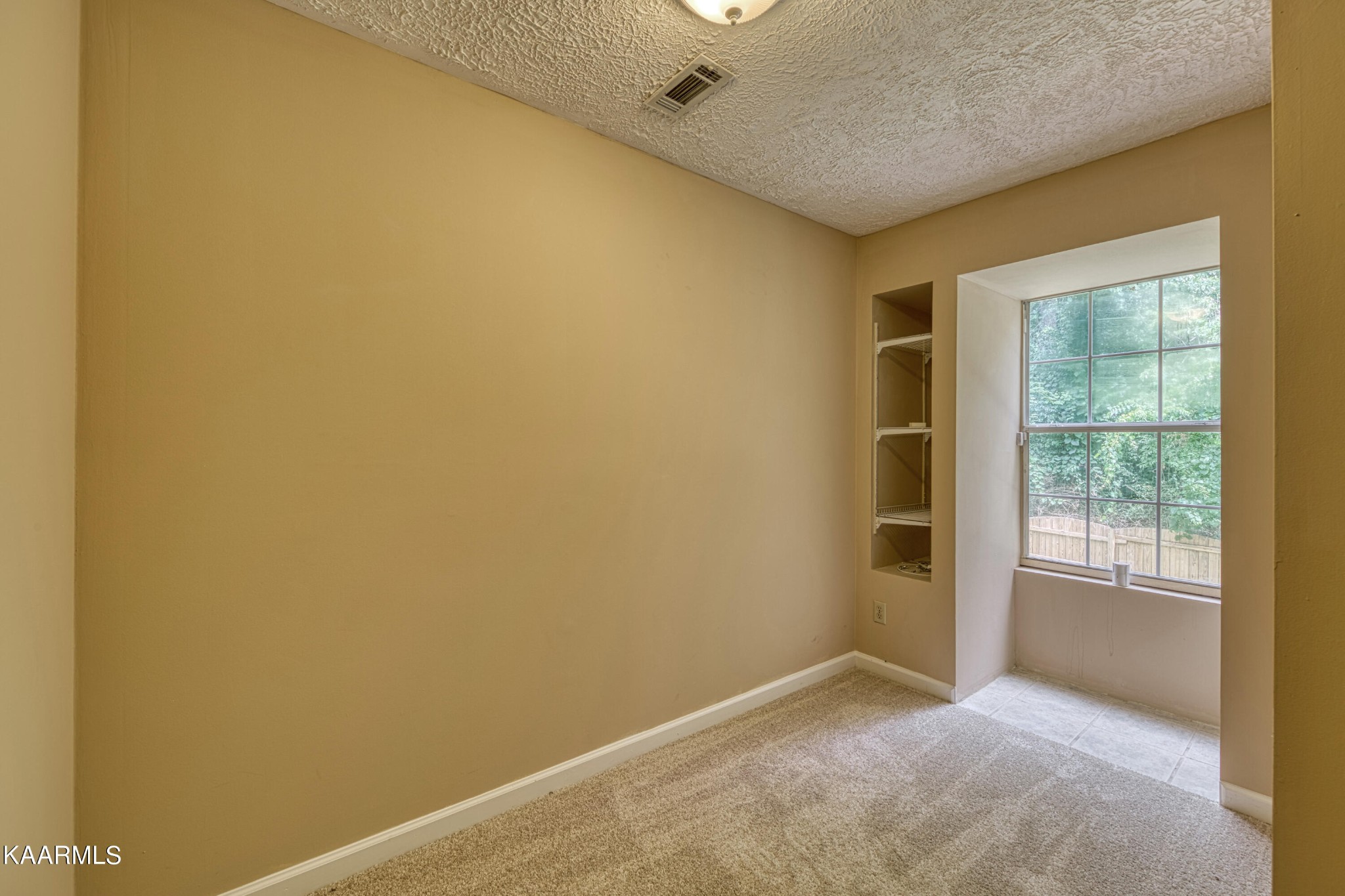 1859 Poplar Hill Road Knoxville, TN 37922 - Photo 26 of 39 an empty room with wooden floor and windows