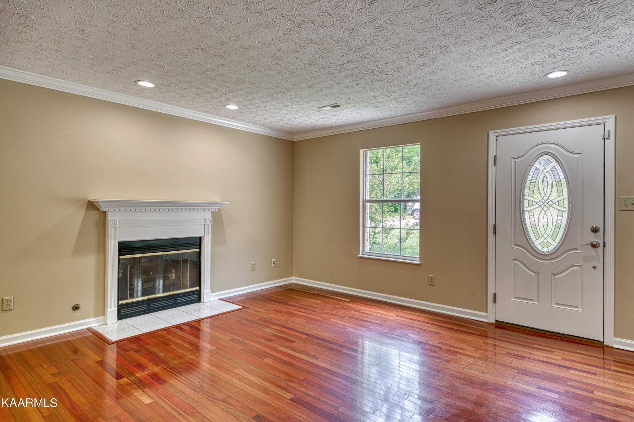 1859 Poplar Hill Road Knoxville, TN 37922 - Photo 4 of 39 a view of an empty room with wooden floor fireplace and a window