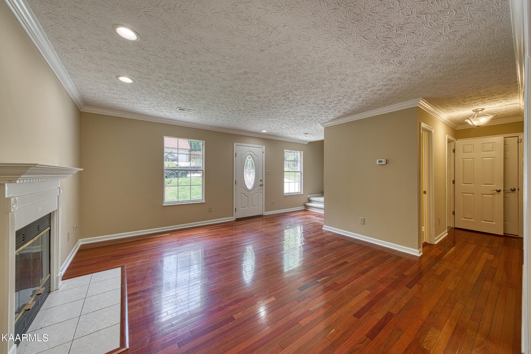 1859 Poplar Hill Road Knoxville, TN 37922 - Photo 5 of 39 a view of an empty room with wooden floor and a window