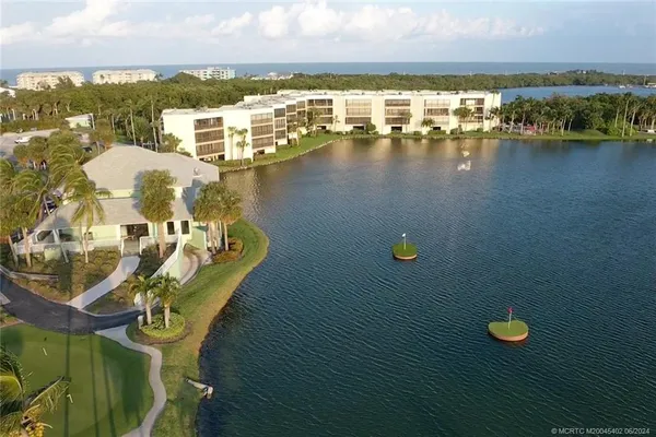 an aerial view of a house with outdoor space and lake view