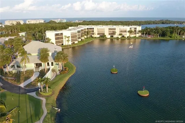 an aerial view of a house with outdoor space and lake view
