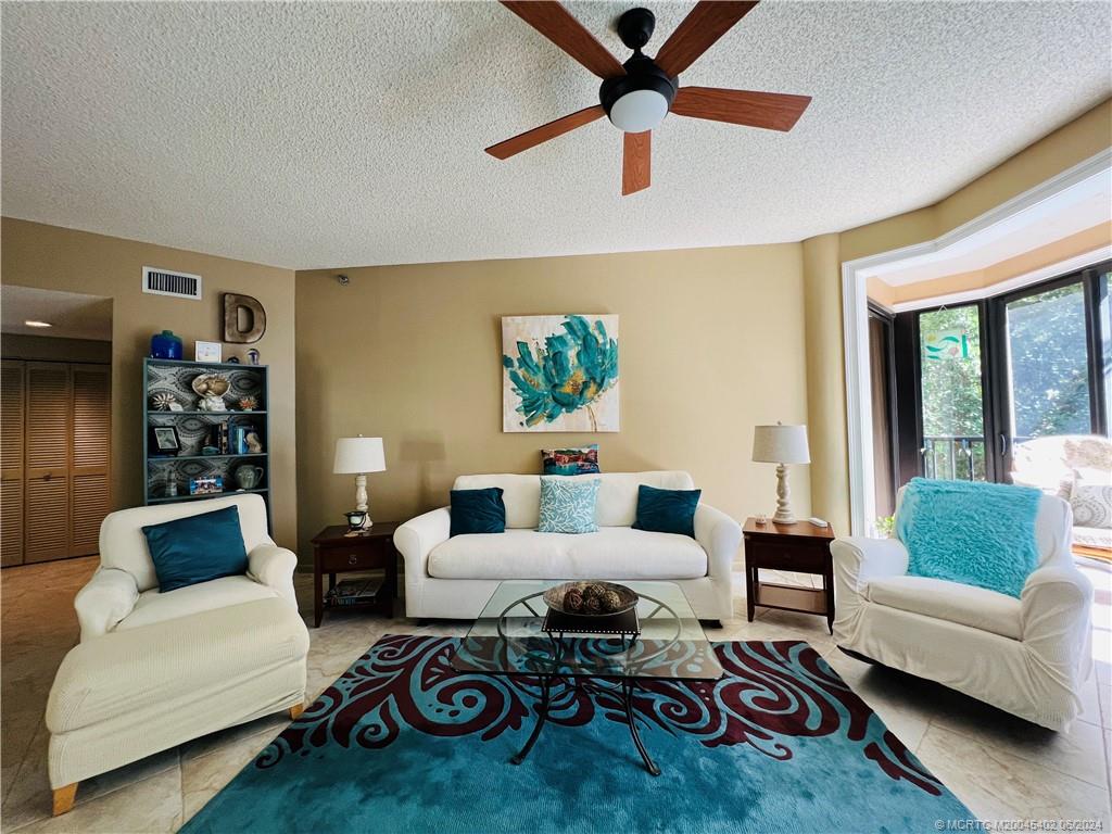 221 Northeast Plantation Road, Unit 215 Stuart, FL 34996 - Photo 15 of 83 a living room with furniture and a rug