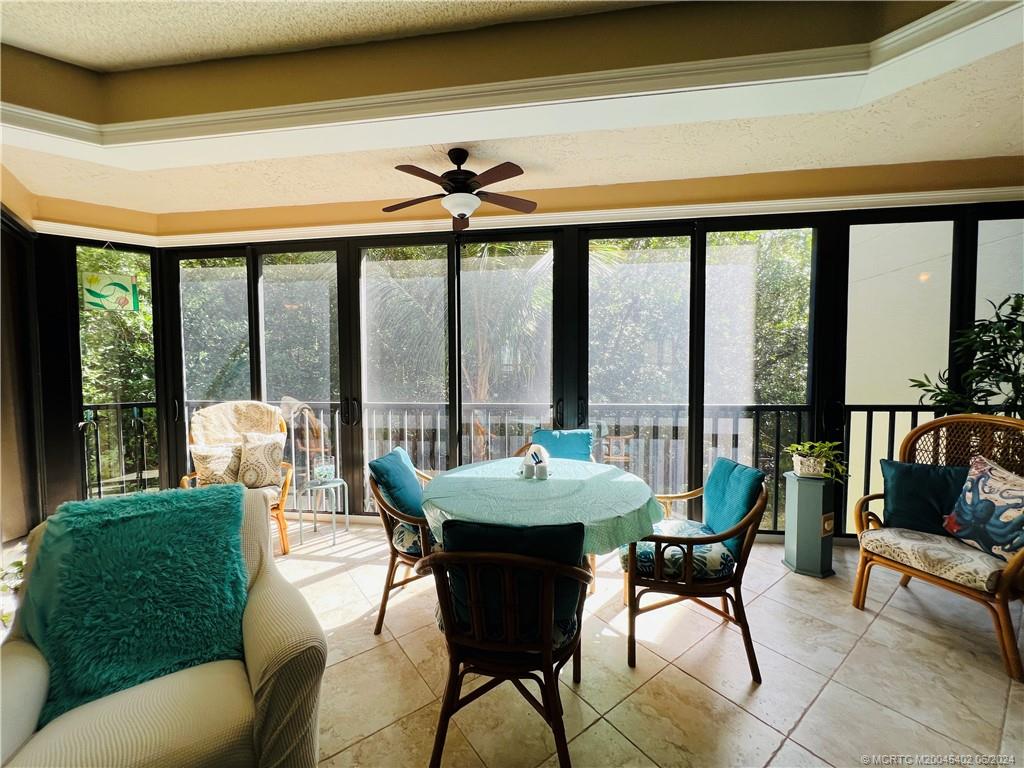 221 Northeast Plantation Road, Unit 215 Stuart, FL 34996 - Photo 19 of 83 a living room with furniture and a large window