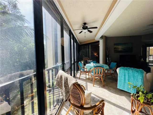 a view of a dining room with furniture and window