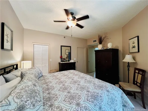 a bedroom with a large bed and a large window