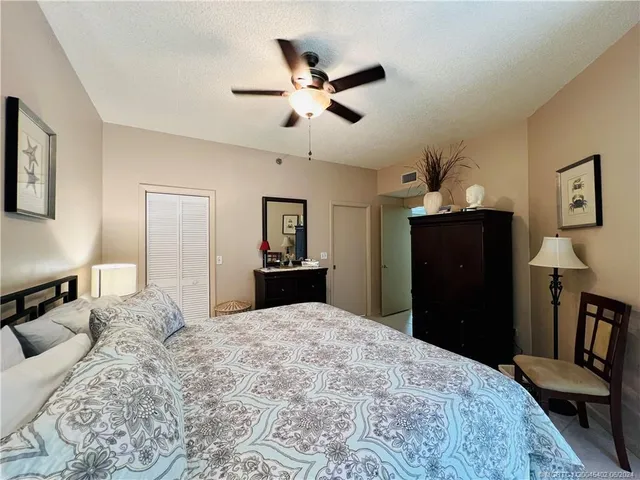 a bedroom with a large bed and a large window