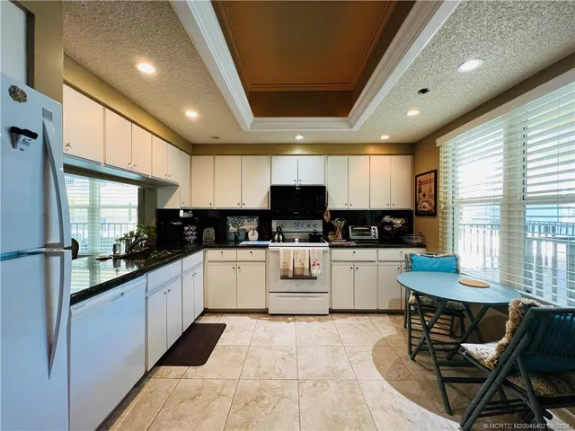 a view of a livingroom with wooden floor and furniture