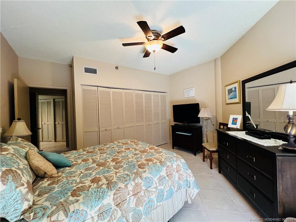 221 Northeast Plantation Road, Unit 215 Stuart, FL 34996 - Photo 52 of 83 a bedroom with a bed and a flat screen tv
