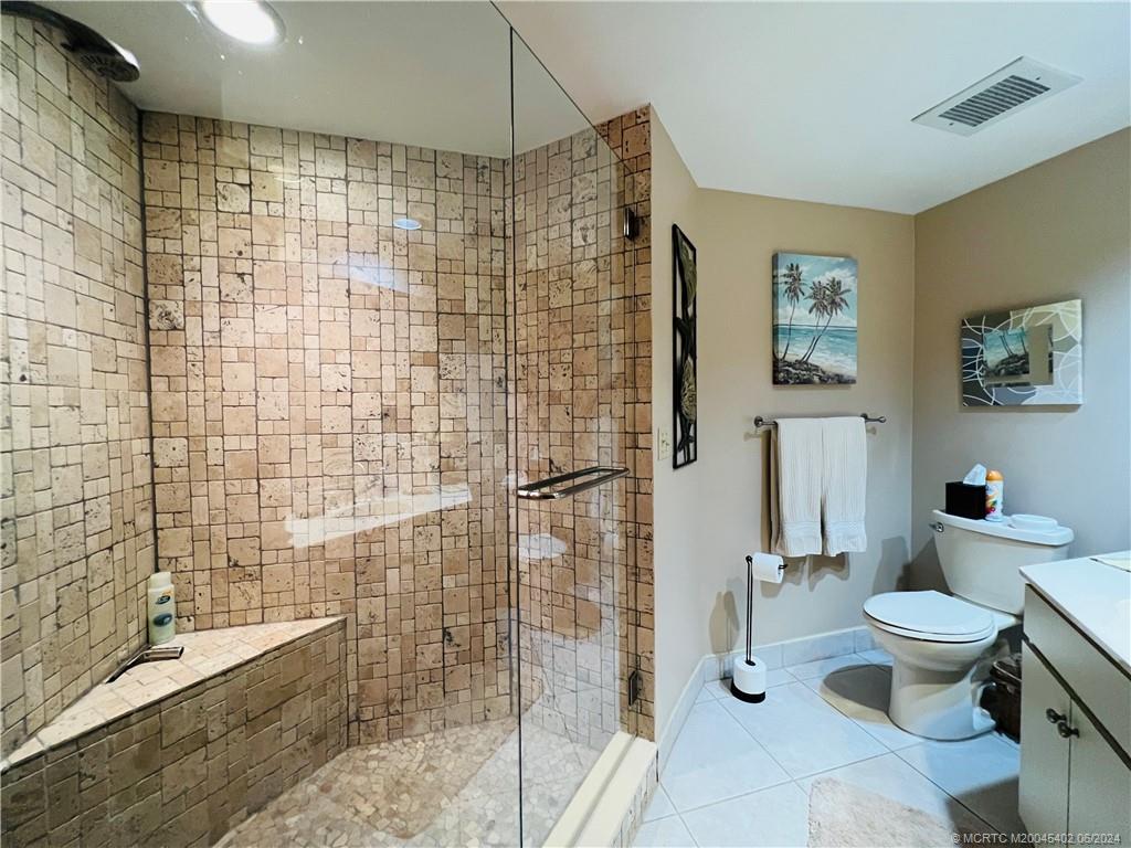 221 Northeast Plantation Road, Unit 215 Stuart, FL 34996 - Photo 58 of 83 a bathroom with a toilet and a shower