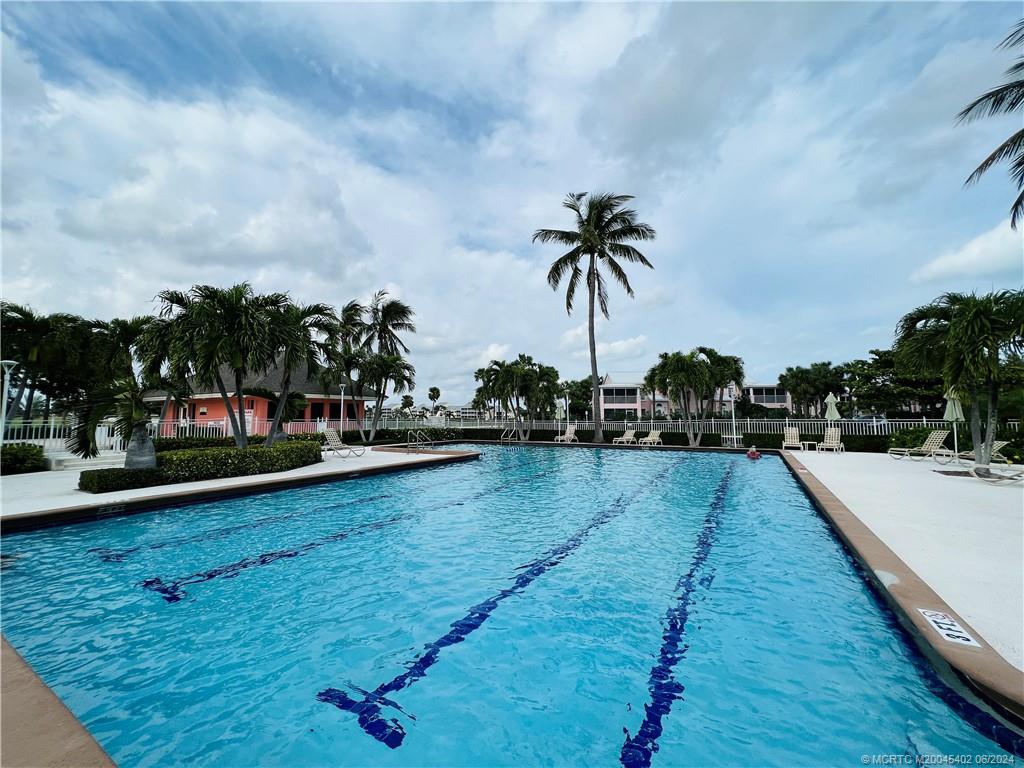 221 Northeast Plantation Road, Unit 215 Stuart, FL 34996 - Photo 72 of 83 a view of swimming pool with outdoor seating and hardwood