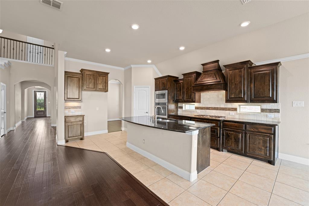 600 Fishback Circle Plano, TX 75074 - Photo 8 of 38 a kitchen with stainless steel appliances granite countertop a refrigerator and a stove top oven