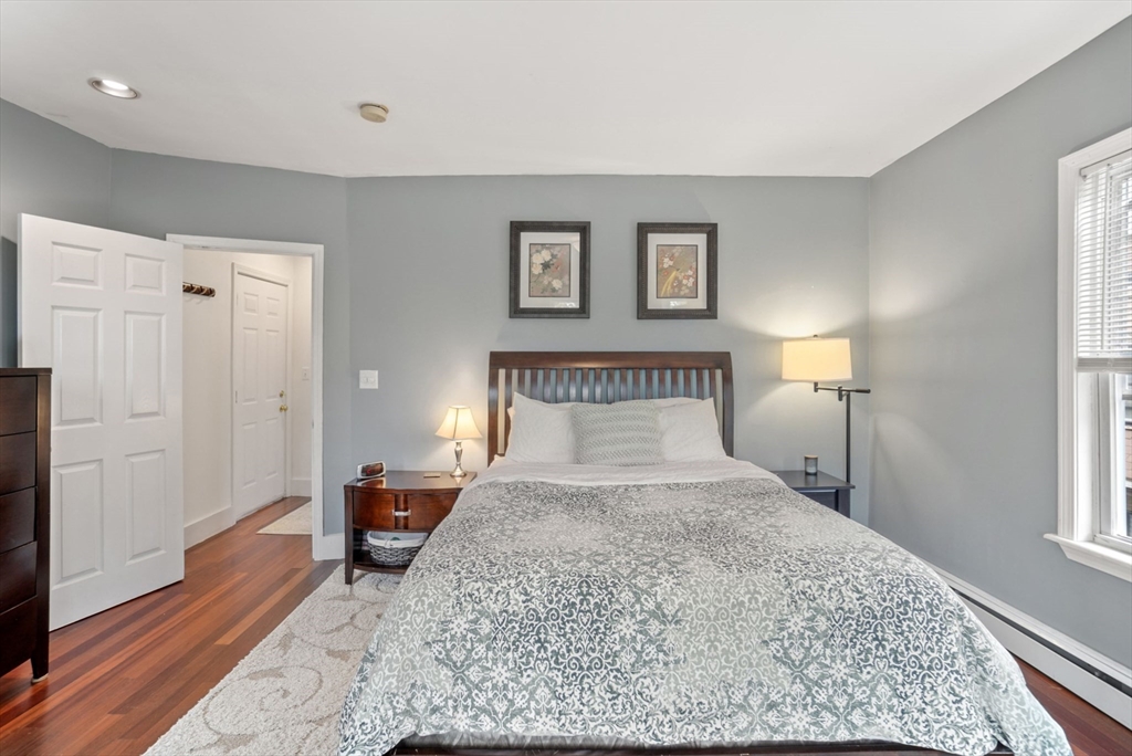 31 Regent Street, Unit 3R Cambridge, MA 02140 - Photo 12 of 28 a bedroom with a bed and wooden floor