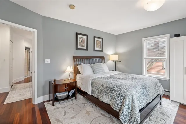 a bedroom with a bed and a night stand