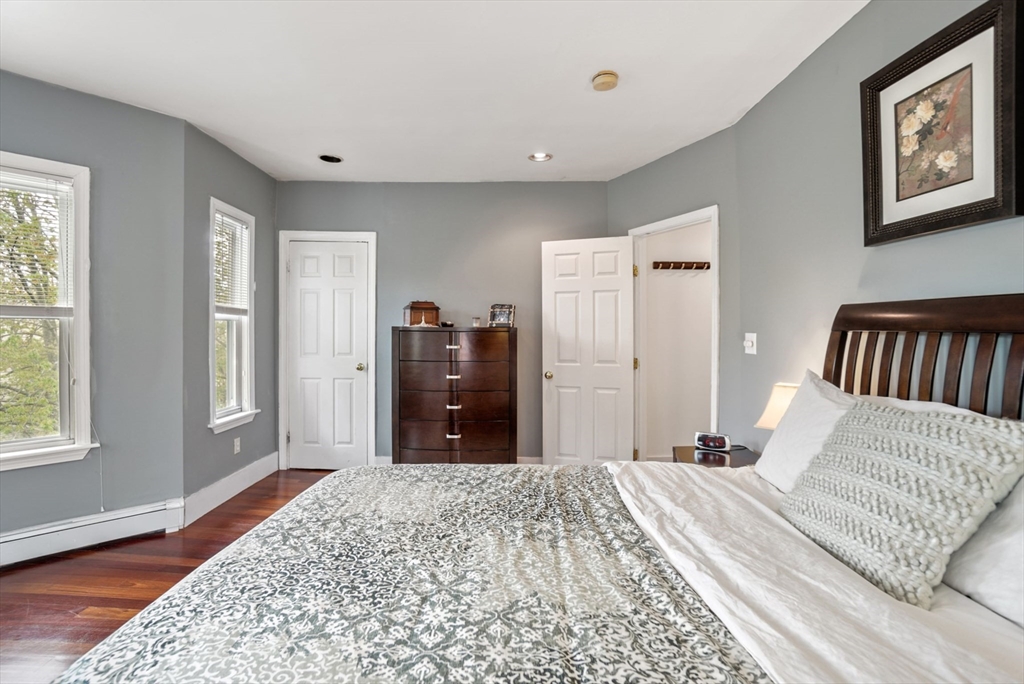 31 Regent Street, Unit 3R Cambridge, MA 02140 - Photo 15 of 28 a bedroom with a bed closet and wooden floor