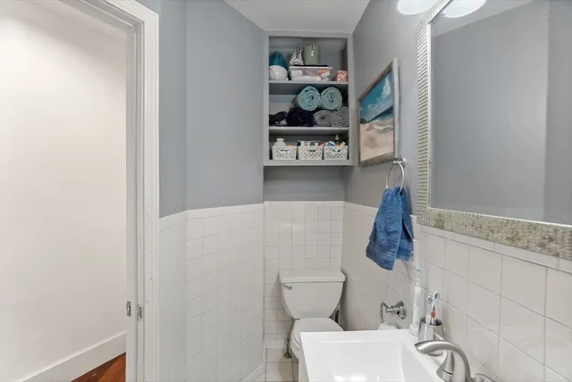a white toilet sitting next to a bathroom sink