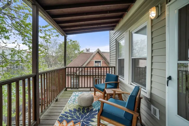 a view of a balcony with furniture