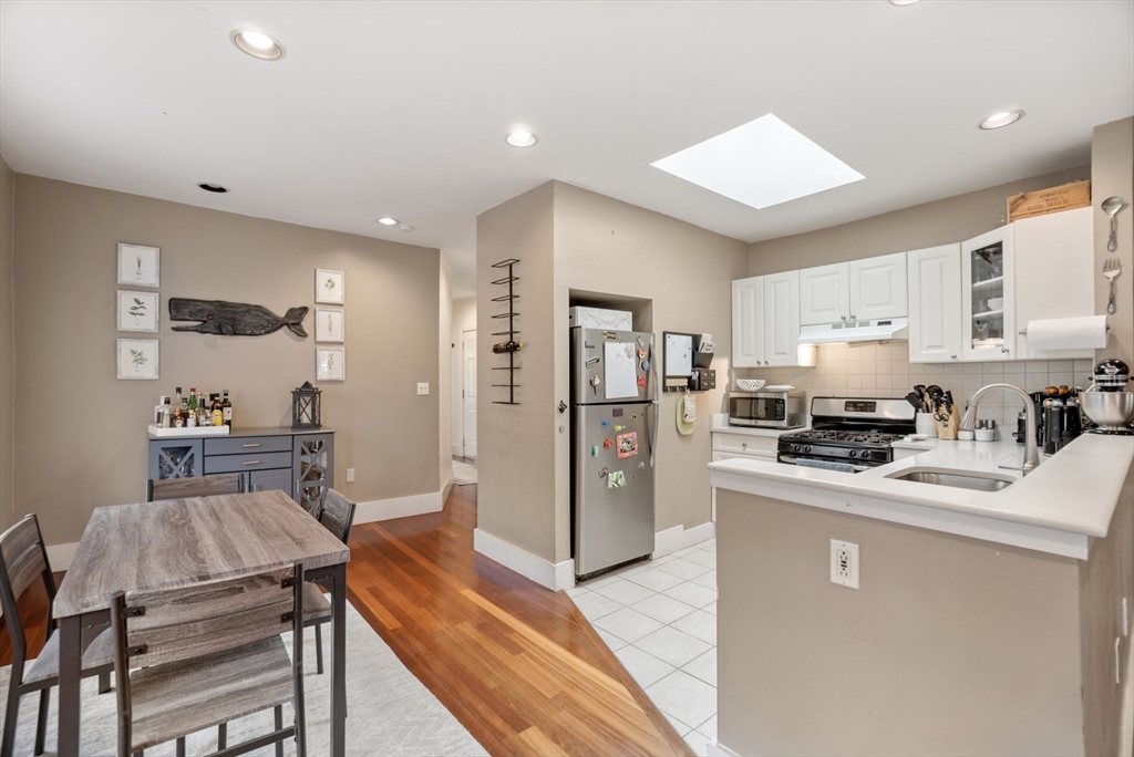 31 Regent Street, Unit 3R Cambridge, MA 02140 - Photo 6 of 28 a kitchen with stainless steel appliances granite countertop a refrigerator stove microwave and sink