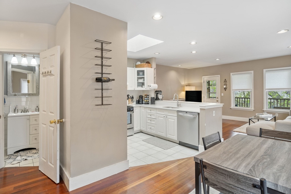 31 Regent Street, Unit 3R Cambridge, MA 02140 - Photo 9 of 28 a kitchen with a refrigerator a sink and wooden floor