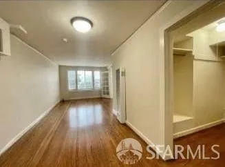 a view of hallway with wooden floor